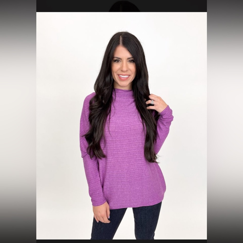Relaxed fit Dolman sleeve sweater. Sleeves are more fitted starting at elbow